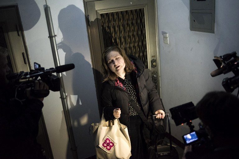 Ursula Gauthier, the Beijing-based correspondent for French news magazine L'Obs, leaves her apartment to take her flight back to France, in Beijing on December 31, 2015. Chinese authorities expelled Gauthier, who was accused of supporting terrorism, with a poll purporting to demonstrate overwhelming support for the decision. AFP PHOTO / FRED DUFOUR / AFP / FRED DUFOUR