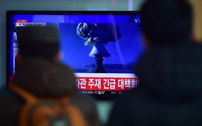 ADDITION- People watch a news report on North Korea's first hydrogen bomb test at a railroad station in Seoul on January 6, 2016. South Korea "strongly" condemned North Korea's shock hydrogen bomb test and vowed to take "all necessary measures" to penalise its nuclear-armed neighbour. The image shown on TV shows files images from other nuclear tests from other countries and the caption in red at the bottom of the screen reads "the Blue House will convene an emergency meeting of the NSC, the National Security Council." AFP PHOTO / JUNG YEON-JE / AFP / JUNG YEON-JE