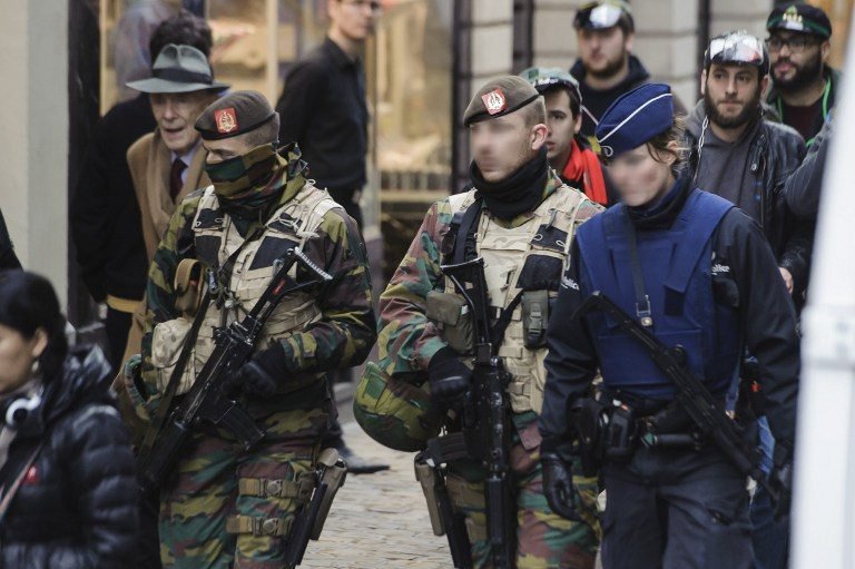 A Belgian soldier stands guard around a security perimeter as a reported police intervention takes place around the Grand Place central square in Brussels on November 22, 2015. Brussels will remain at the highest possible alert level with schools and metros closed over a "serious and imminent" security threat in the wake of the Paris attacks, the Belgian prime minister said. AFP PHOTO / EMMANUEL DUNAND / AFP / EMMANUEL DUNANDA Belgian soldier stands guard around a security perimeter as a reported police intervention takes place around the Grand Place central square in Brussels on November 22, 2015. Brussels will remain at the highest possible alert level with schools and metros closed over a "serious and imminent" security threat in the wake of the Paris attacks, the Belgian prime minister said. AFP PHOTO / EMMANUEL DUNAND / AFP / EMMANUEL DUNAND