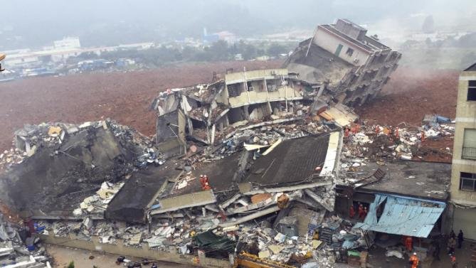 Rescuers search for survivors amongst collapsed buildings after a landslide in Shenzhen, in south China's Guangdong province, Sunday Dec. 20, 2015. The landslide collapsed and buried buildings at and around an industrial park in the southern Chinese city of Shenzhen on Sunday authorities reported. (Chinatopix via AP) CHINA OUT